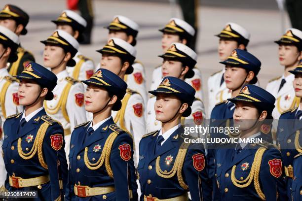 Chinese honour guard arrive for the welcoming ceremony for French President Emmanuel Macron and China's President Xi Jinping in Beijing on April 6,...