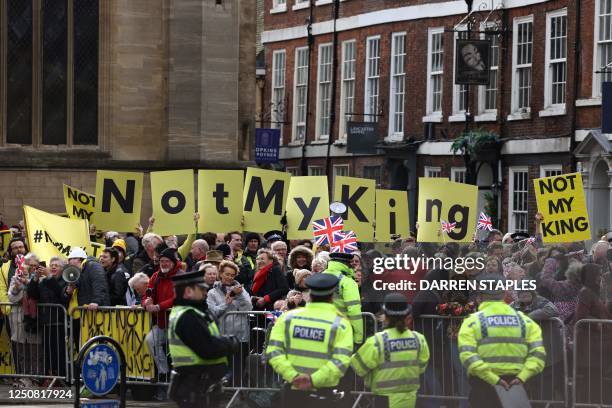 Protesters hold up placards saying 'Not My King' ahead of the arrival of Britain's King Charles III and Britain's Camilla, Queen Consort outside York...