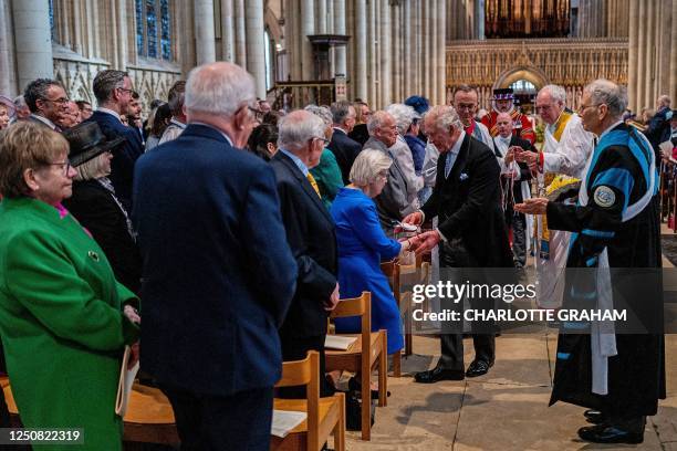 Britain's King Charles III distributes the Maundy money to 74 men and 74 women, mirroring the age of the monarch, in York Minster, northern England...