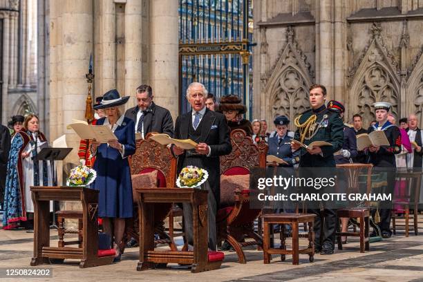 Britain's King Charles III and Britain's Camilla, Queen Consort attend the Royal Maudy Service where the King distributes the Maundy money to 74 men...