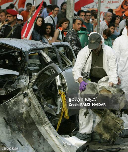 Federal Bureau of Investigation agent checks the wrecked car of assassinated Lebanese journalist Samir Kassir, a columnist on the leading An-Nahar...