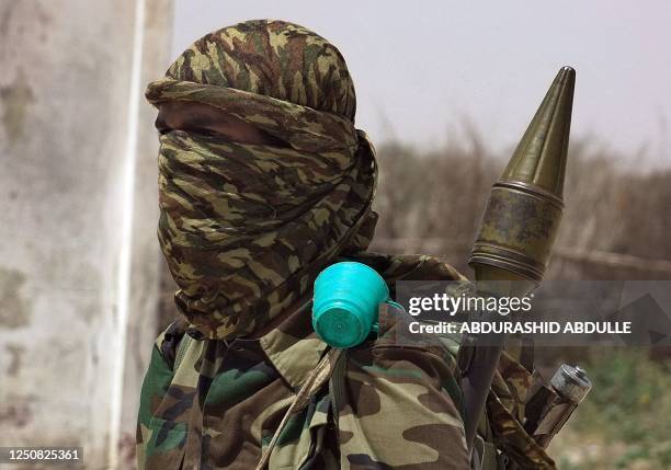 An Islamist fighter loyal to Somalia's Al-Qaida inspired al-Shebab group holds his arms during military drills in a village in the Lower Shabelle...