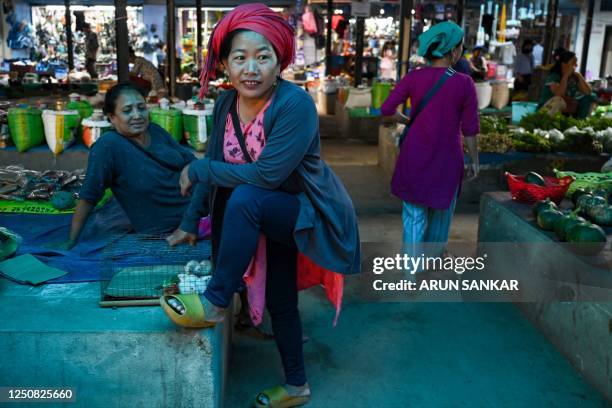 Vendors gesture while they wait for customers at a market in Dimapur town in northeast Indian state of Nagaland on April 6, 2023.