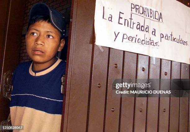 Displaced child from the community of La Diana, in Valle de Cauca, opens a door of a house where he and other displaced people have found refuge as a...