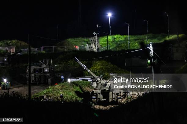 Israeli self-propelled artillery howitzers are stationed at an Israeli army base in Zawra in the Israeli-annexed Golan Heights on April 6, 2023. -...