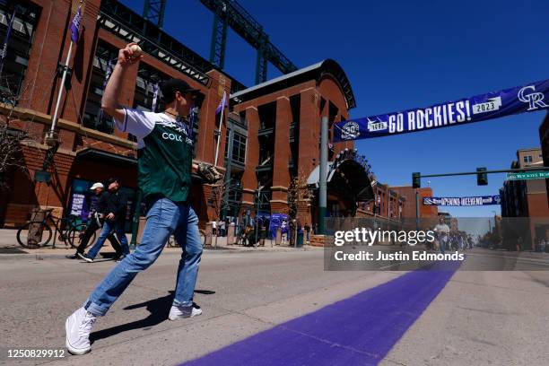 Johnny Hergert and Will Fraizer play catch on Blake Street before the Washington Nationals take on the Colorado Rockies on Opening Day at Coors Field...