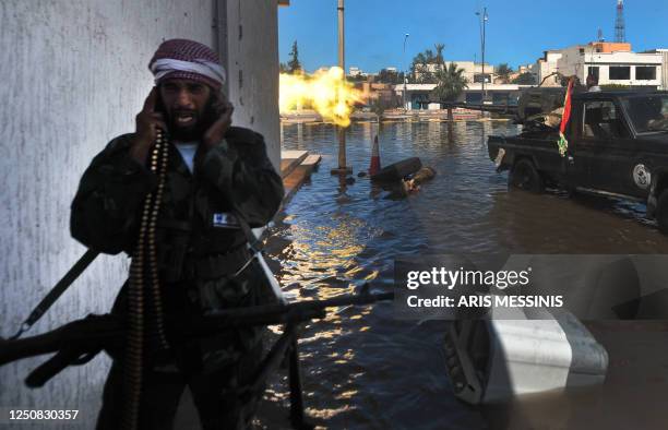 National Transitional Council fighters fire at forces loyal to Moamer Kadhafi during battles in Sirte on October 12, 2011 as Libya's new regime...