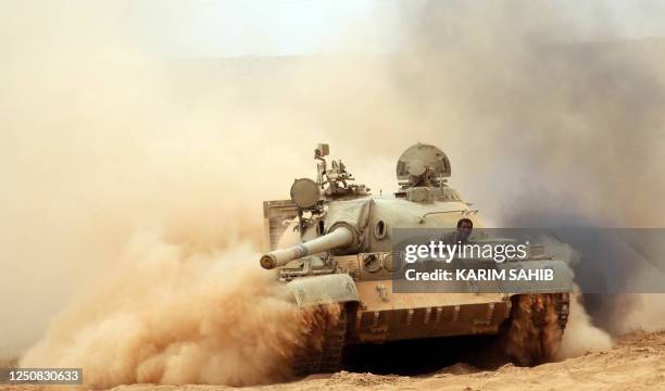 Libyan National Transitional Council fighter looks out from a tank during battles on the frontline in the desert city of Bani Walid on October 3 as...