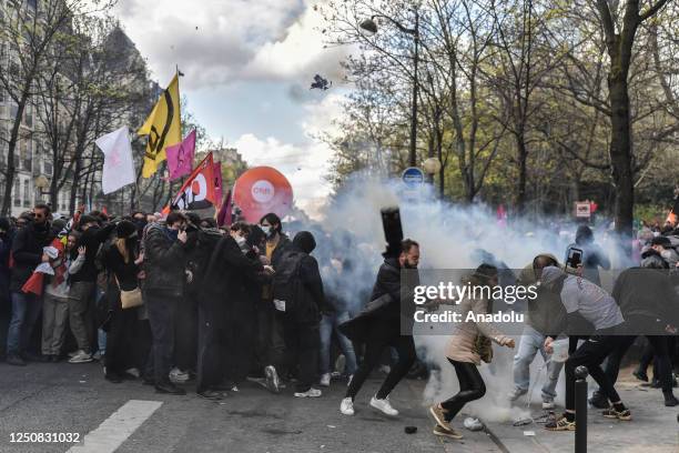 Riot police use tear gas while clashes with demonstrators during a protest against the government after pushing the pensions reform without a vote...