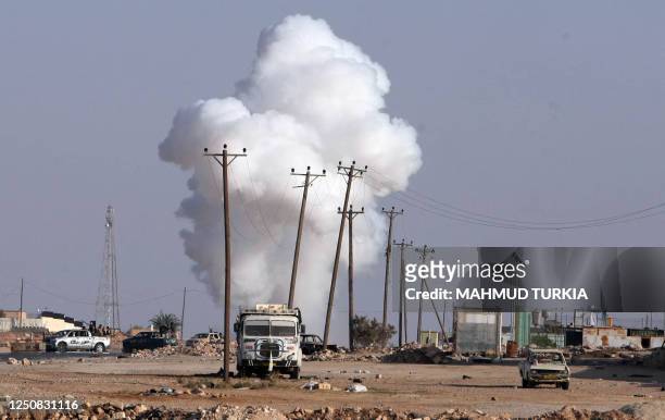 White smoke billows in the air during clashes between Kadhafi loyalists and Libyan National Transition Council fighters in the Bani Walid Kadhafi...