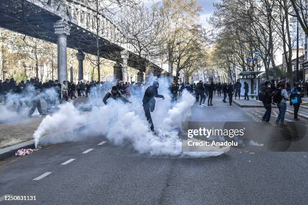 Protestor kicking a tear gas bomb back at the riot police during a protest against the government after pushing the pensions reform without a vote...