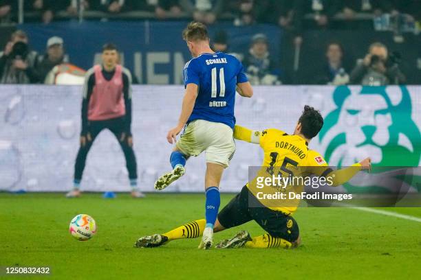 Marius Buelter of FC Schalke 04 and Mats Hummels of Borussia Dortmund battle for the ball during the Bundesliga match between FC Schalke 04 and...
