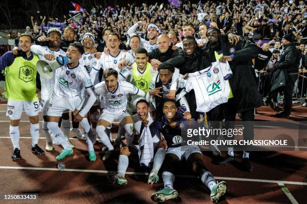 Toulouse's players celebrate after winning the French Cup semi-final football match between FC Annecy and Toulouse FC at the Parc Des Sports Stadium...