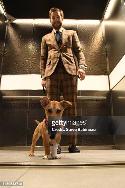 Linus Ullmark of the Boston Bruins with a dog from the MSPCA before the game against the Toronto Maple Leafs at the TD Garden on April 6, 2023 in...