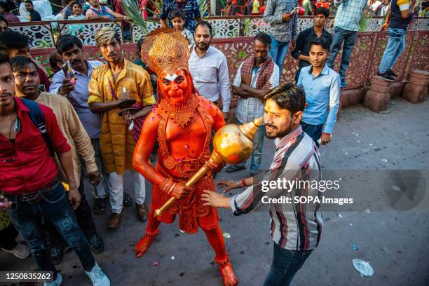 An Indian Hindu devotee dressed as the Monkey God, Hanuman during a procession for the Hindu festival Hanuman Jayanti. The festival commemorates the...