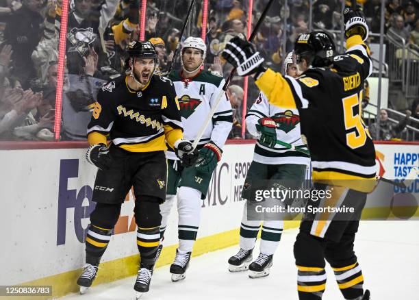 Pittsburgh Penguins defenseman Kris Letang celebrates his goal with Pittsburgh Penguins left wing Jake Guentzel during the first period in the NHL...