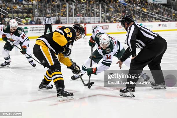 Minnesota Wild Center Joel Eriksson Ek and Pittsburgh Penguins Center Sidney Crosby face-off during the second period in the NHL game between the...