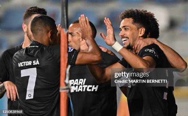 Botafogo's midfielder Carlos Eduardo celebrates with teammates after scoring during the Copa Sudamericana group stage first leg football match...