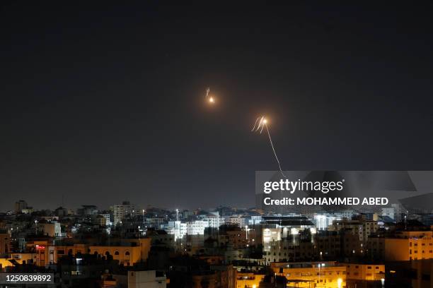 Streaks of light are seen as Israel's Iron Dome air defence system intercepts rockets fired from the Gaza Strip into Israeli territory on April 7,...