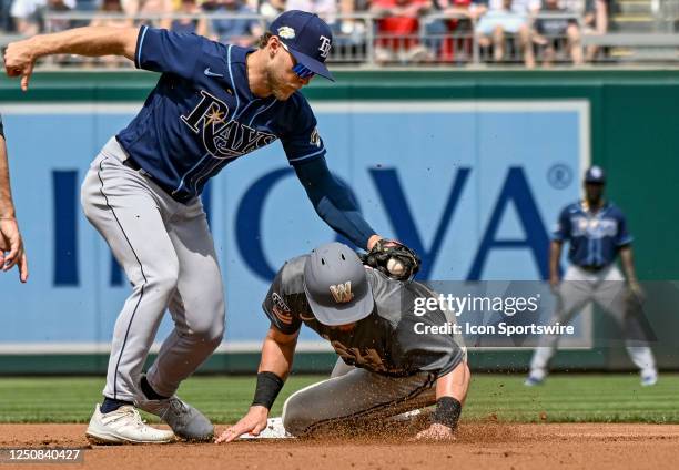 April 05: Tampa Bay Rays second baseman Taylor Walls takes the late throw on a steal by Washington Nationals right fielder Lane Thomas during the...