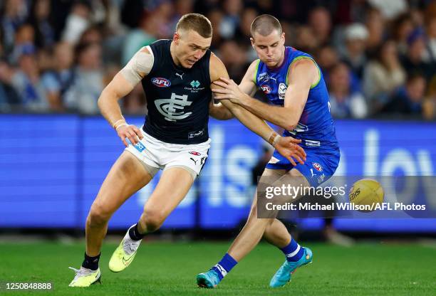 Patrick Cripps of the Blues and Bailey Scott of the Kangaroos in action during the 2023 AFL Round 04 match between the North Melbourne Kangaroos and...