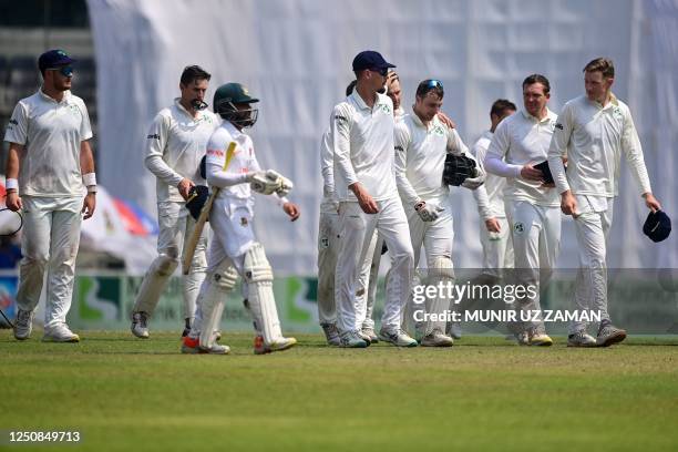 Bangladesh's and Ireland's players walk back to the pavilion at the end of the fourth day of the Test cricket match between Bangladesh and Ireland at...