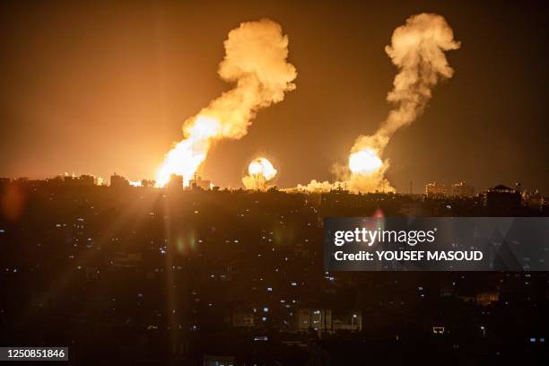 This picture taken early on April 7, 2023 shows explosions in Khan Yunis in the southern Gaza Strip during Israeli air strikes on the Palestinian...