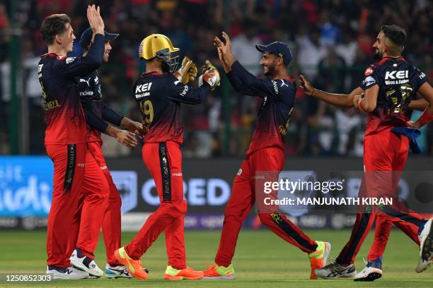 Royal Challengers Bangalore's players celebrate after the dismissal of Mumbai Indians' Suryakumar Yadav during the Indian Premier League Twenty20...