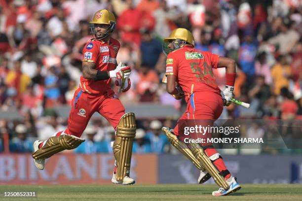 Punjab Kings' Shikhar Dhawan and Bhanuka Rajapaksa run between the wickets during the Indian Premier League Twenty20 cricket match between Punjab...