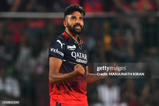 Royal Challengers Bangalore's Mohammed Siraj celebrates after taking the wicket of Mumbai Indians' Ishan Kishan during the Indian Premier League...