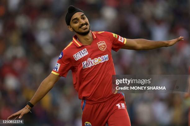 Punjab Kings' Arshdeep Singh celebrate after the dismissal of Kolkata Knight Riders' Mandeep Singh during the Indian Premier League Twenty20 cricket...