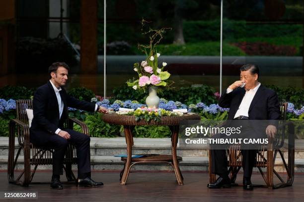 Chinese President Xi Jinping and French President Emmanuel Macron attend a tea ceremony at the Guandong province governor's residence in Guangzhou on...