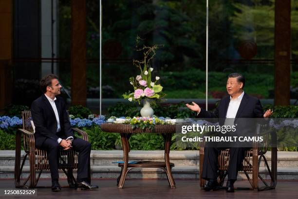 Chinese President Xi Jinping and French President Emmanuel Macron attend a tea ceremony at the Guandong province governor's residence in Guangzhou on...