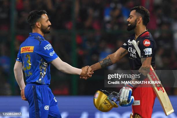 Mumbai Indians' Ramandeep Singh greets Royal Challengers Bangalore's Virat Kohli at the end of the Indian Premier League Twenty20 cricket match...