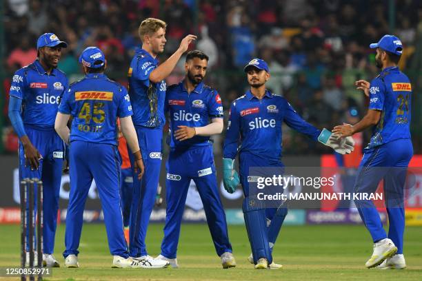 Mumbai Indians' players celebrate after the dismissal of Royal Challengers Bangalore's Dinesh Karthik during the Indian Premier League Twenty20...