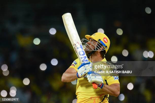 Chennai Super Kings' captain Mahendra Singh Dhoni watches the ball after playing a shot during the Indian Premier League Twenty20 cricket match...