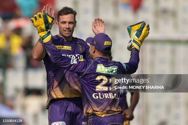 Kolkata Knight Riders' Tim Southee celebrates with teammate Rahmanullah Gurbaz after taking the wicket of Punjab Kings' Prabhsimran Singh during the...