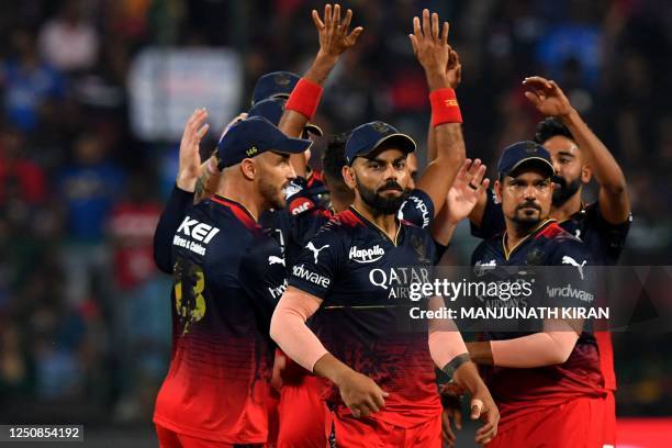 Royal Challengers Bangalore's players celebrate after the dismissal of Mumbai Indians' Ishan Kishan during the Indian Premier League Twenty20 cricket...