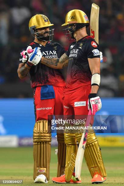 Royal Challengers Bangalore's Virat Kohli and Faf du Plessis celebrate their 100 runs partnership during the Indian Premier League Twenty20 cricket...