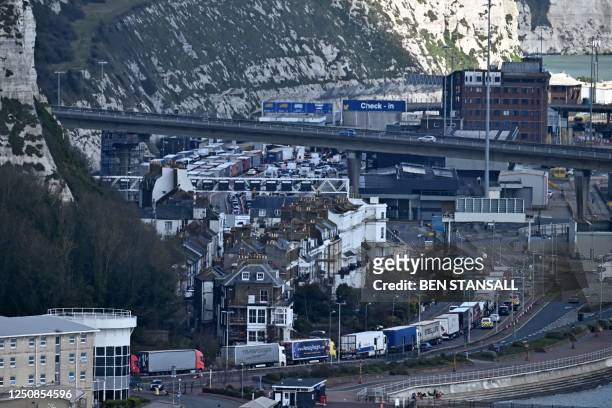 Container lorries queue on the A20 leading to the Port of Dover on the south-east coast of England before boarding ferries to mainland Europe on...