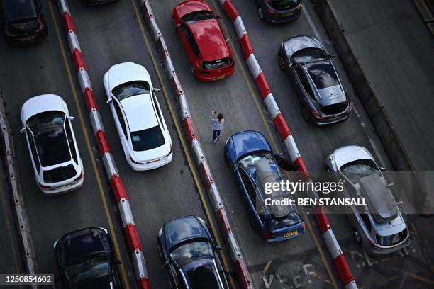 Drivers stretch their legs as holiday traffic queues to enter the Port of Dover on the south-east coast of England before boarding ferries to...