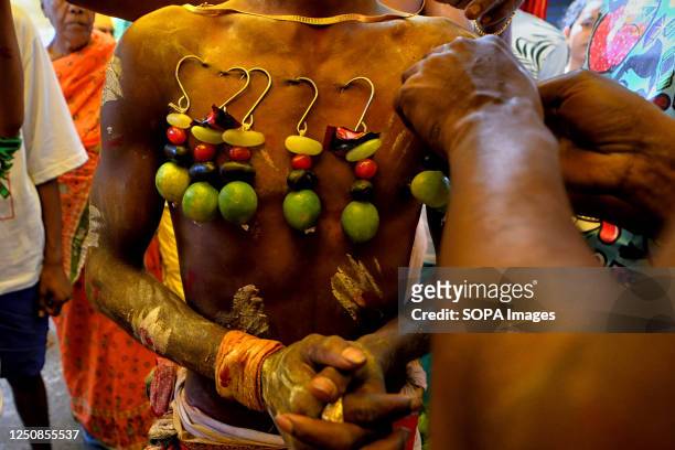 Devotee pierces his skin during a religious procession to mark Bhel Bhel festival dedicated to Hindu goddess Muthumariamman in Bandel town in the...