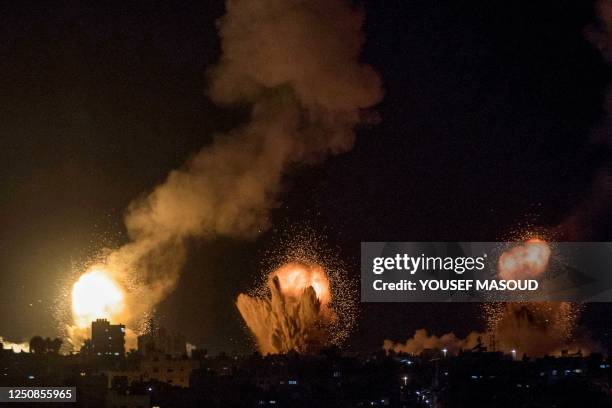 This picture taken early on April 7, 2023 shows explosions in Khan Yunis in the southern Gaza Strip during Israeli air strikes on the Palestinian...