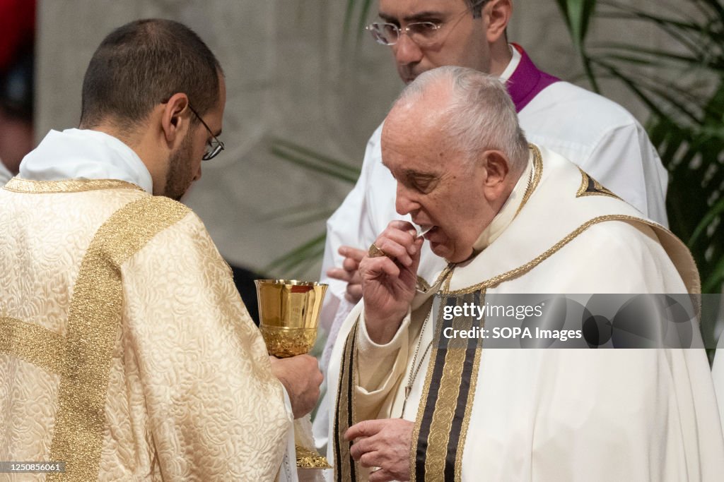 Pope Francis receives the Communion during the Chrism Mass...