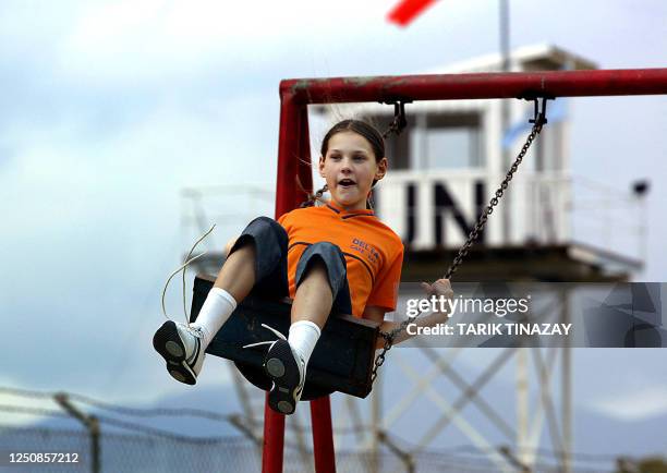 Turkish Cypriot girl plays in a park near the UN buffer zone on referandum day in the Turkish side of divided Nicosia, 24 April 2004. Turkish...