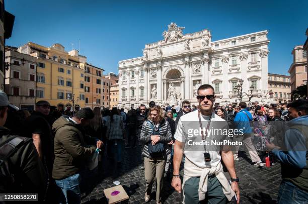 Rome, Italy, on April 7 is bustling with tourists before the Easter holidays on Good Friday at the Trevi Fountain.