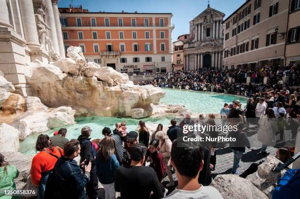 Rome, Italy, on April 7 is bustling with tourists before the Easter holidays on Good Friday at the Trevi Fountain.