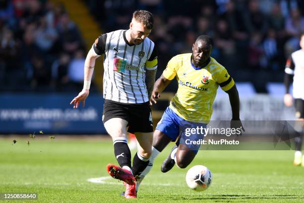 Kyle Cameron of Notts County under pressure from Olufela Olomola of Wealdstone during the Vanarama National League match between Notts County and...