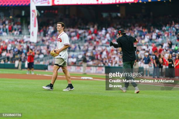 Stetson Bennett throws out the ceremonial first pitch before the game against the San Diego Padres in the Braves season home opener at Truist Park on...
