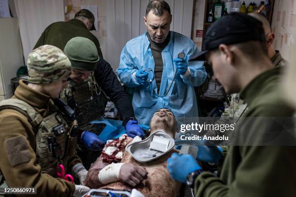 Ukrainian medics of the battalion "Da Vinci Wolves" and "Ulf" paramedical unit treat a wounded Ukrainian soldier on the Bakhmut front as...